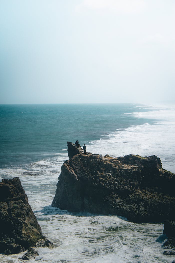 Majestic rocky cliff over a turquoise sea at Tasikmalaya, West Java, Indonesia, showcasing stunning natural beauty.